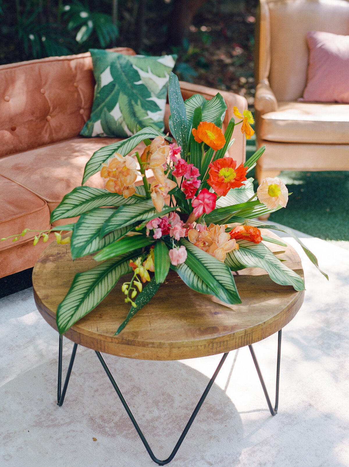 Same centerpiece on this simple brown round wood table.