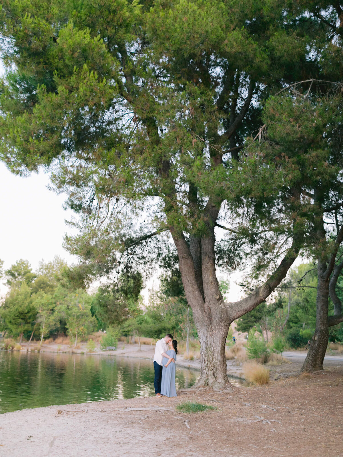 wide angle photo of couple maternity announcement