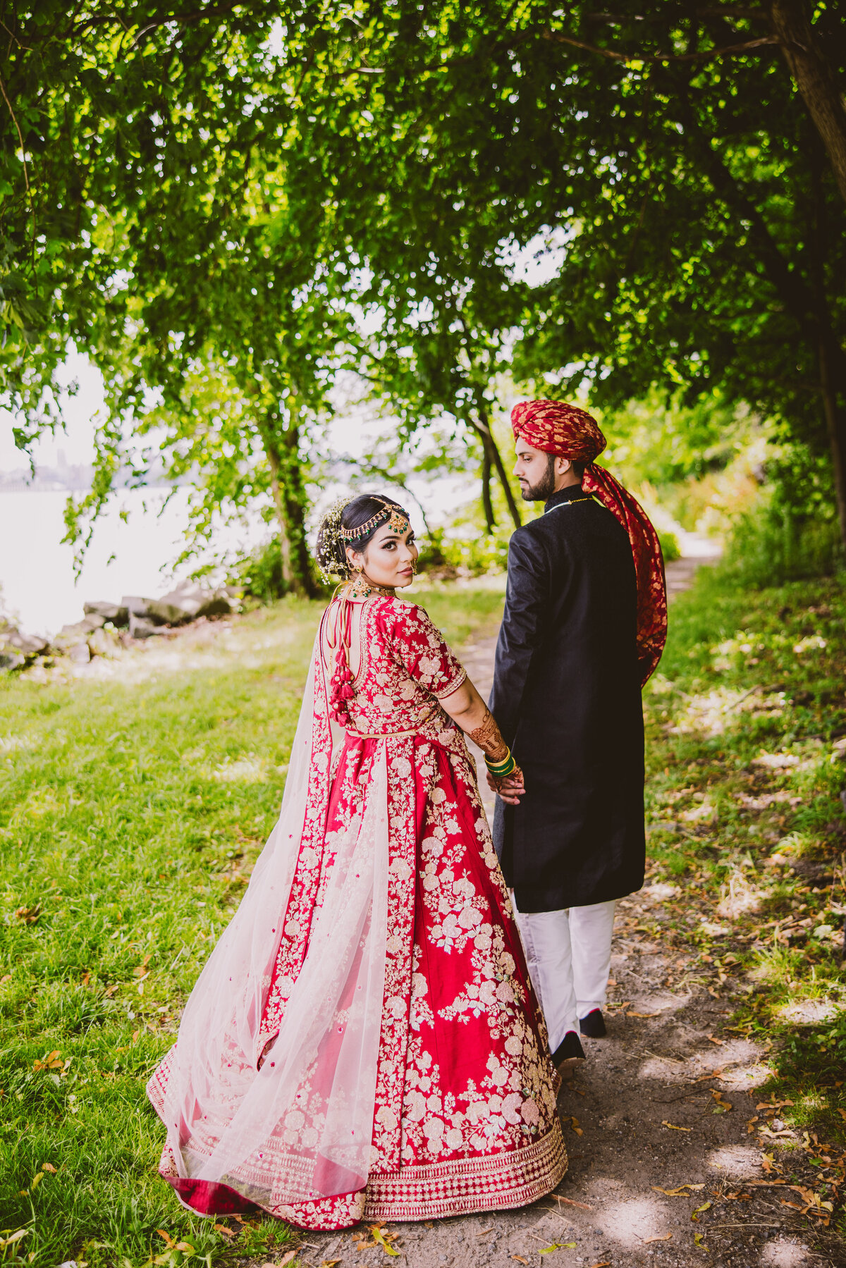 bengali bride looking back at the camera with pakistani groom before their muslim wedding at fort lee nj