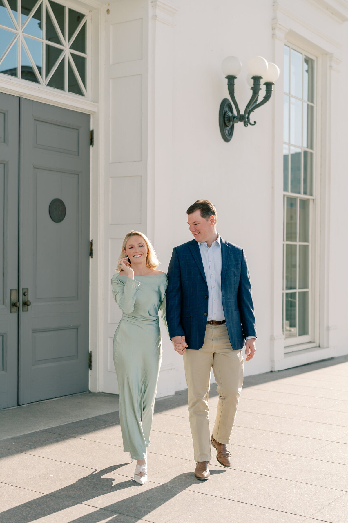 Engagement Photographer Richmond VA | couple walks hand-in-hand at the Virginia State Capitol Building