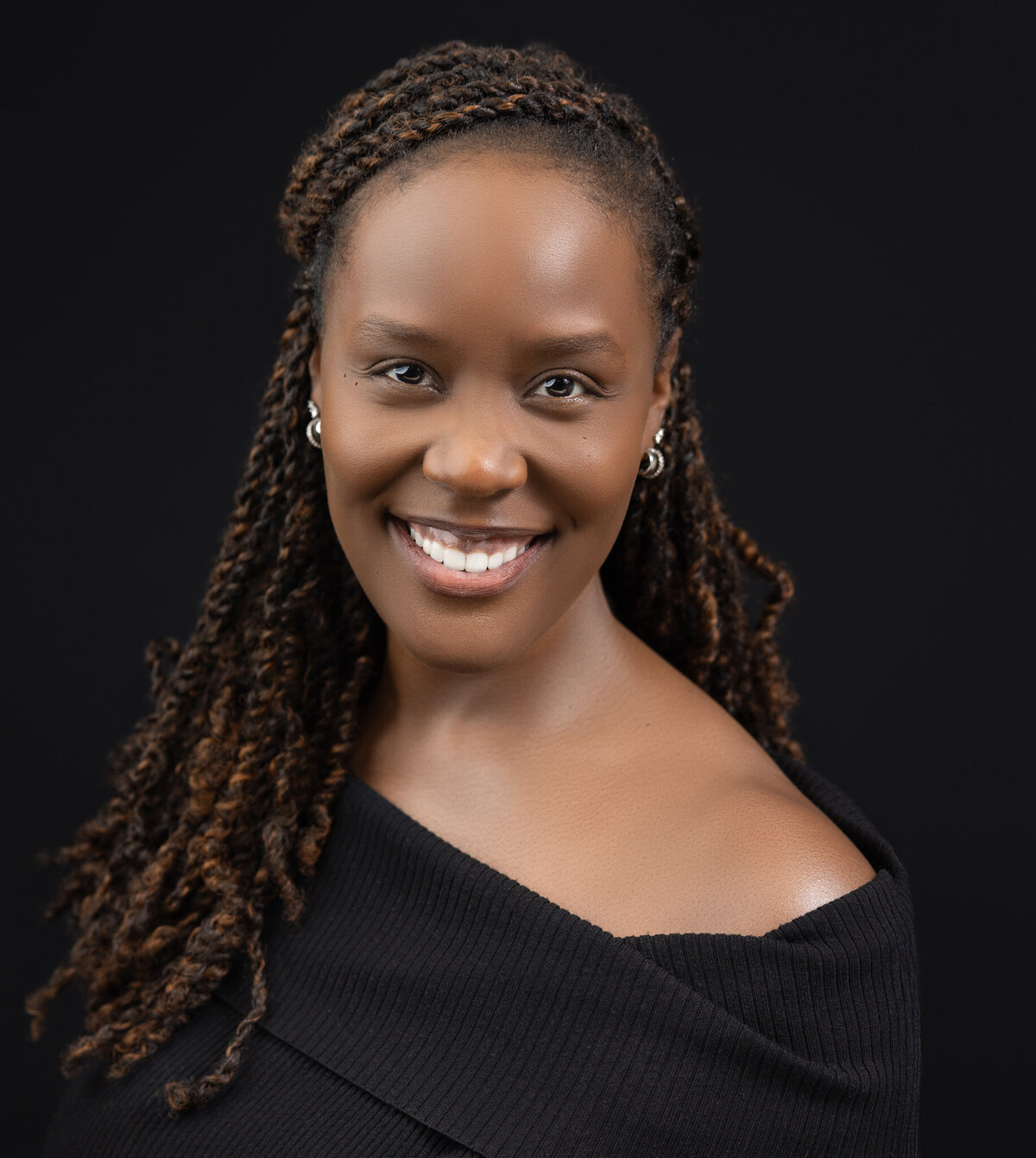 headshot of a woman in a black blouse