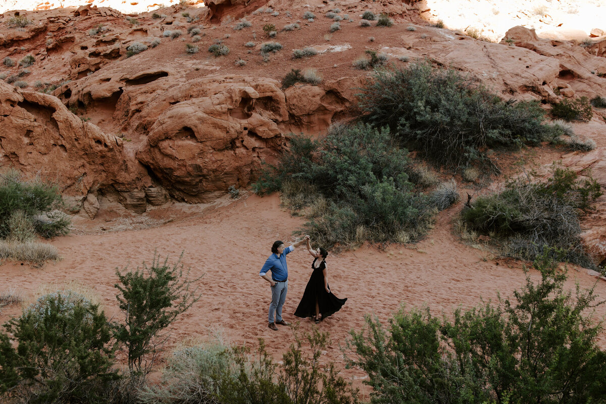 Two people twirl around during an engagement photoshoot at Valley of Fire.