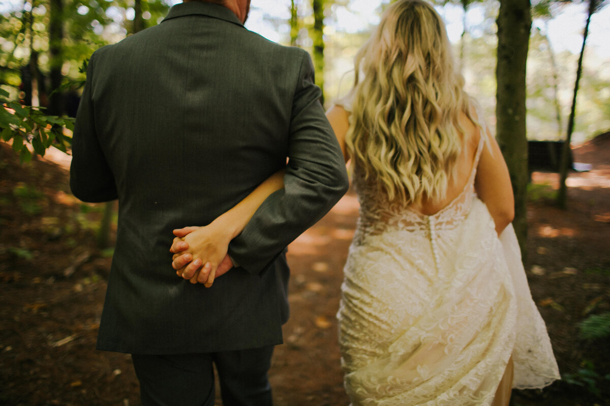 A groom and bride hold hands