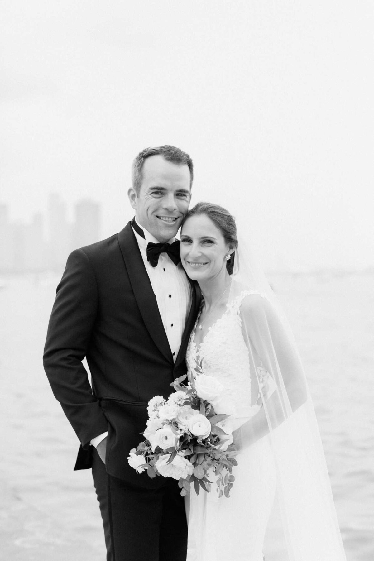 Black and white lakefront wedding day photo with bride's veil and bouquet for their Luxury Chicago Outdoor Historic Wedding Venue.