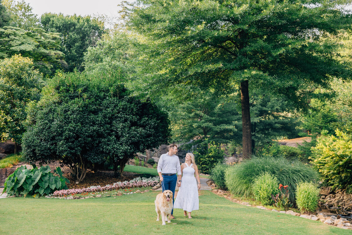 engagement couple walking with their dog at the rock quarry for an engagement session