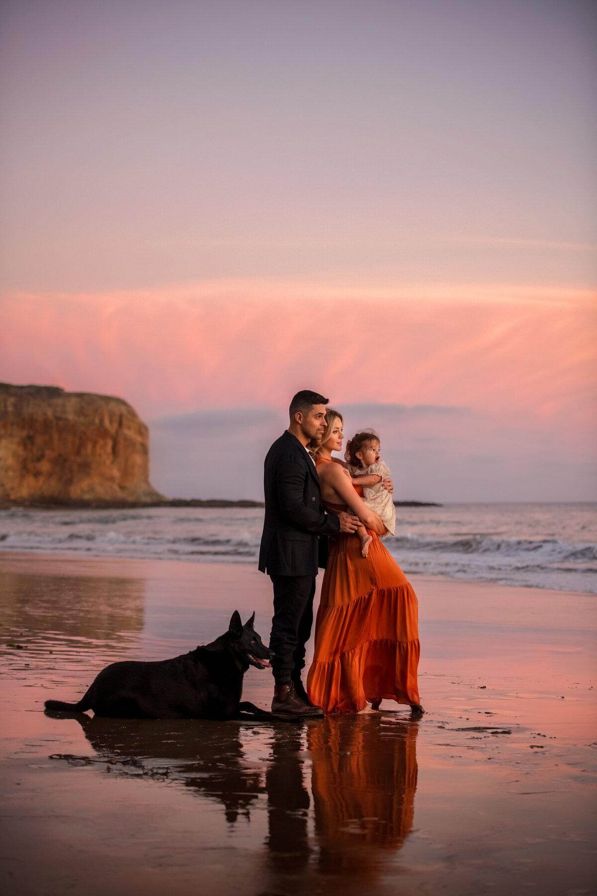 Wilmer Valderrama with his wife, daughter and dog enjoying pink sunset at Palos Verdes beach in California.