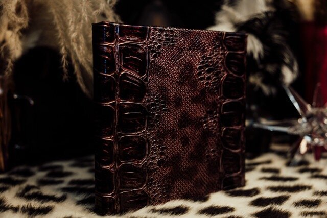 Boudoir photography keepsake album on leopard rug in Lubbock, Texas photographer in Amarillo TX