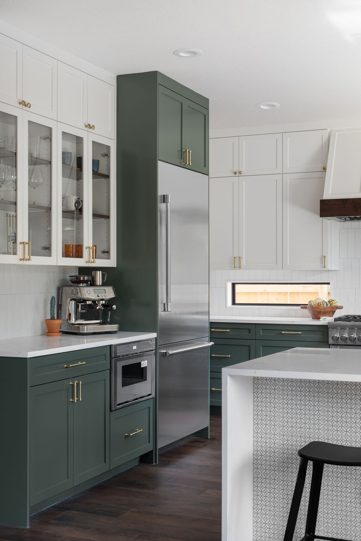 hello-home-austin-waterfall-peninsula-two-tone-kitchen-remodel-countertop-window-green-cabinets-tile-on-peninsula-7