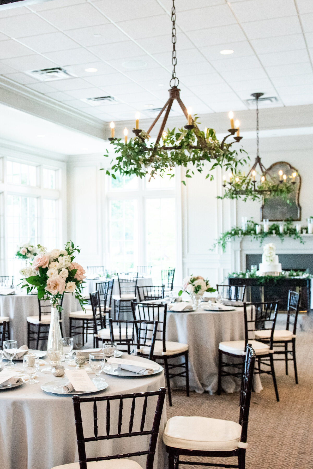 white wedding reception with greenery