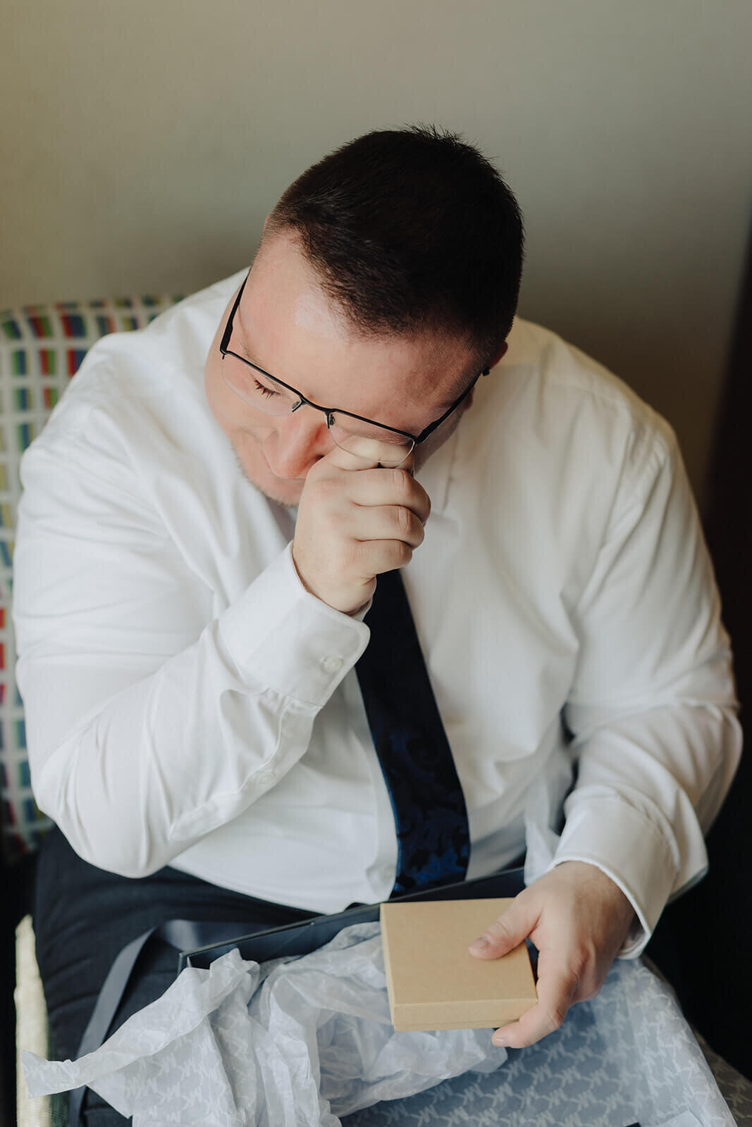 Man looking emotional holding a book