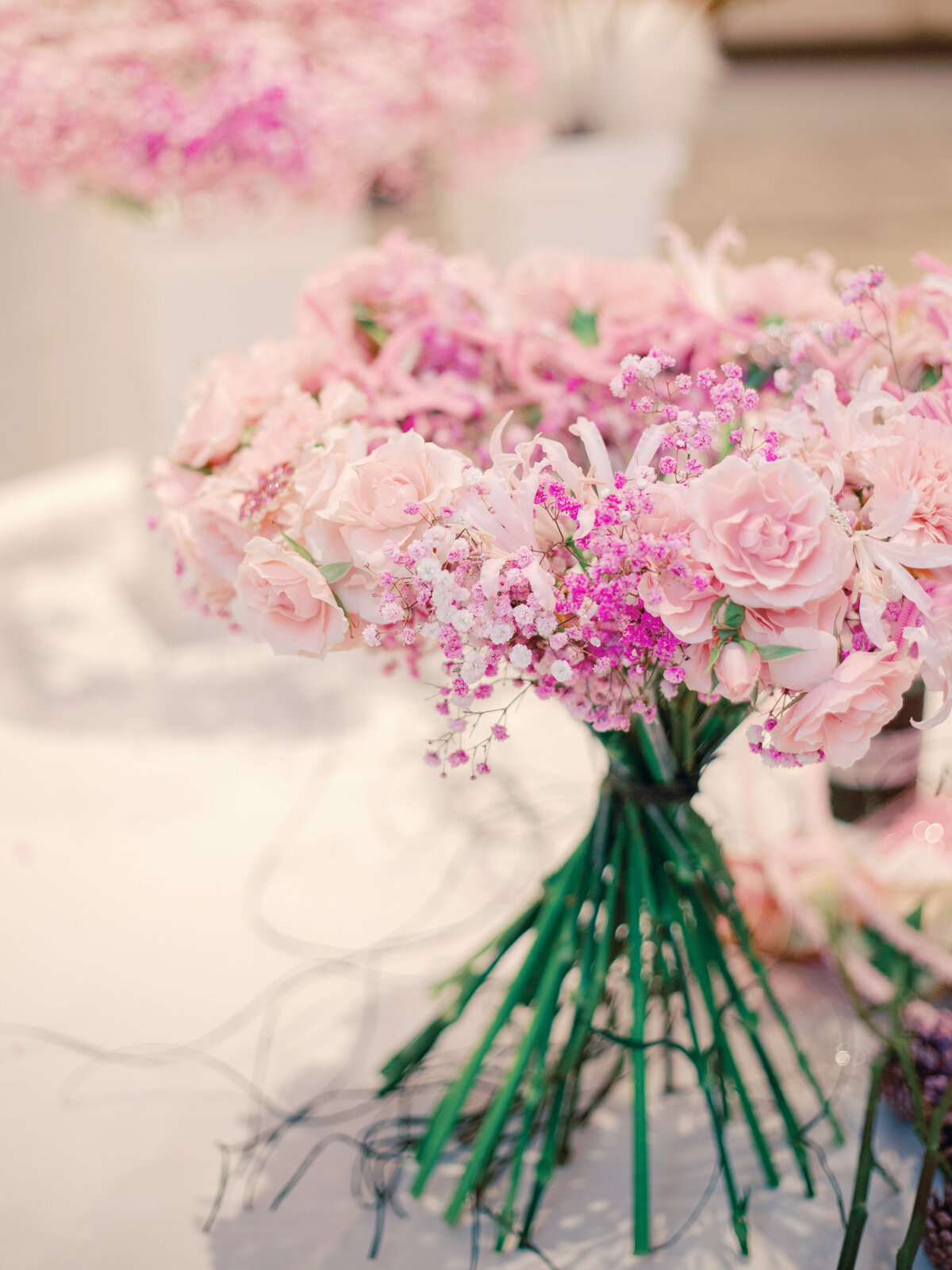 A breathtaking bridal bouquet featuring a delicate spiral arrangement of pink roses intertwined with airy baby’s breath. This romantic and timeless floral design exudes elegance, making it the perfect choice for brides seeking a soft, feminine, and sophisticated wedding bouquet.