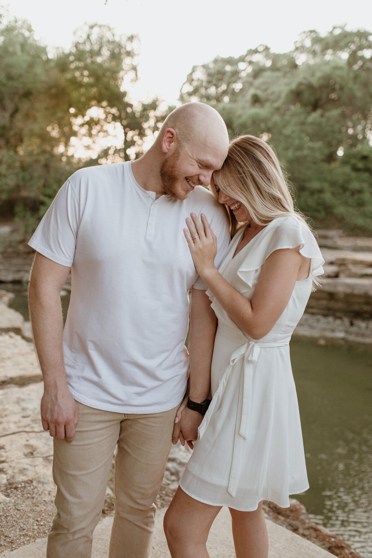A romantic sunset moment of an engaged couple at Airfield Falls captured by Fort Worth Wedding Photographer, Megan Christine Studio