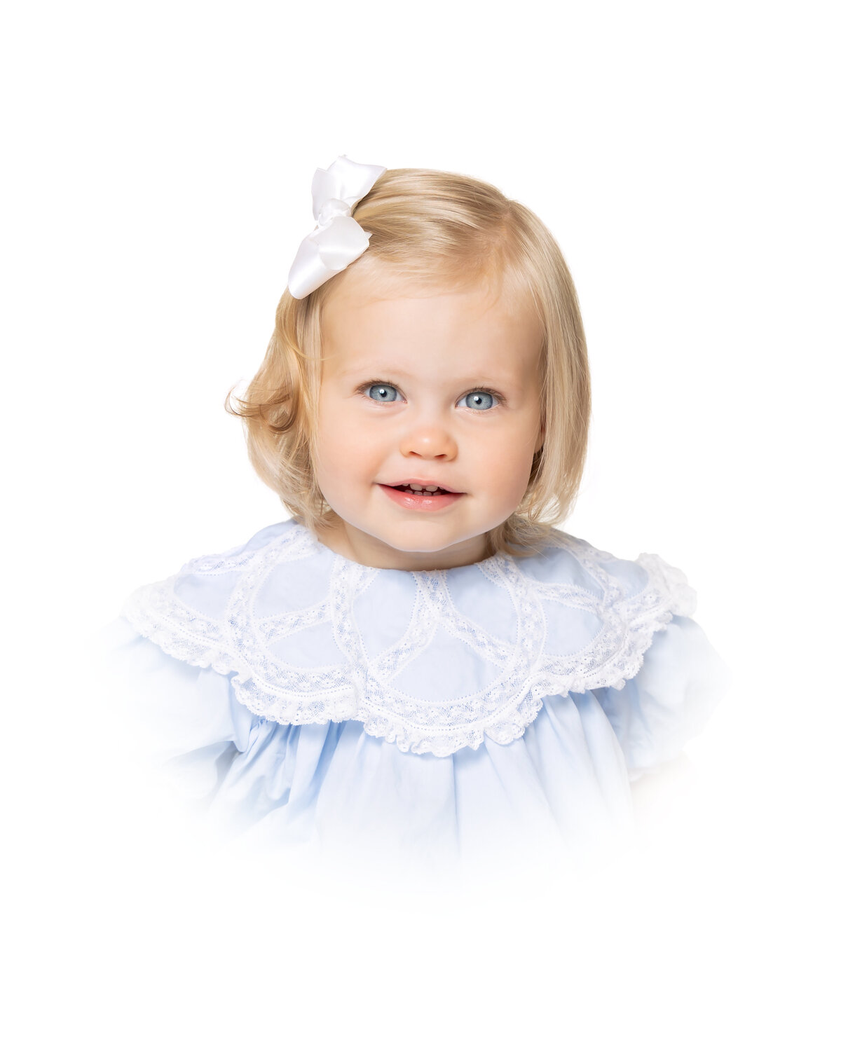 Heirloom portrait of a little girl in a vintage-style blue dress, with a white vignette.