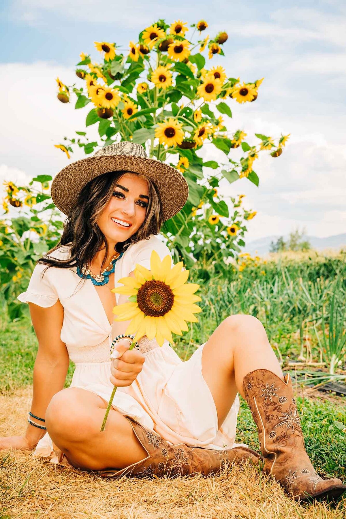 Senior photo of girl holding sunflower at Turner Farms, Missoula