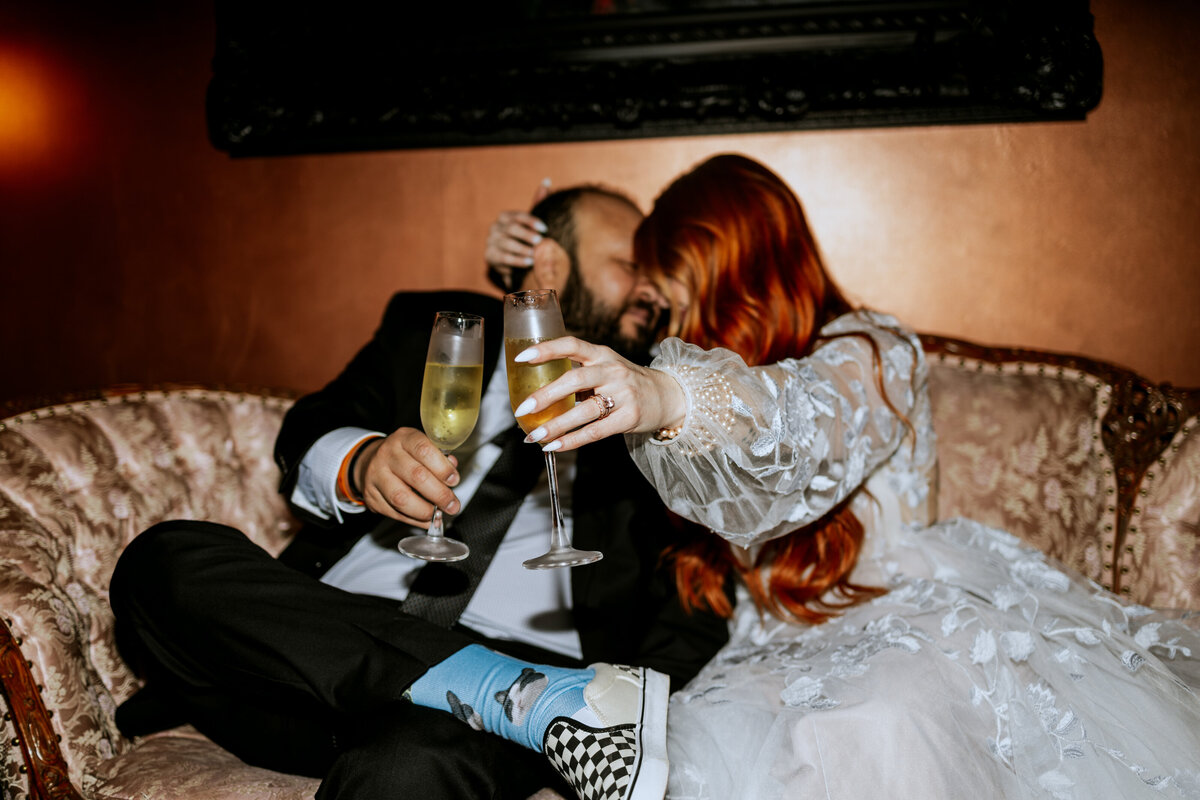 Couple holding champagne glasses with flash photography in jerome arizona