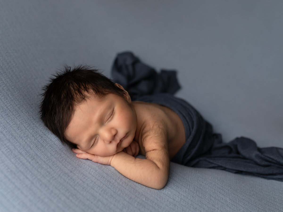 photo of newborn baby boy in blue for studio portraits