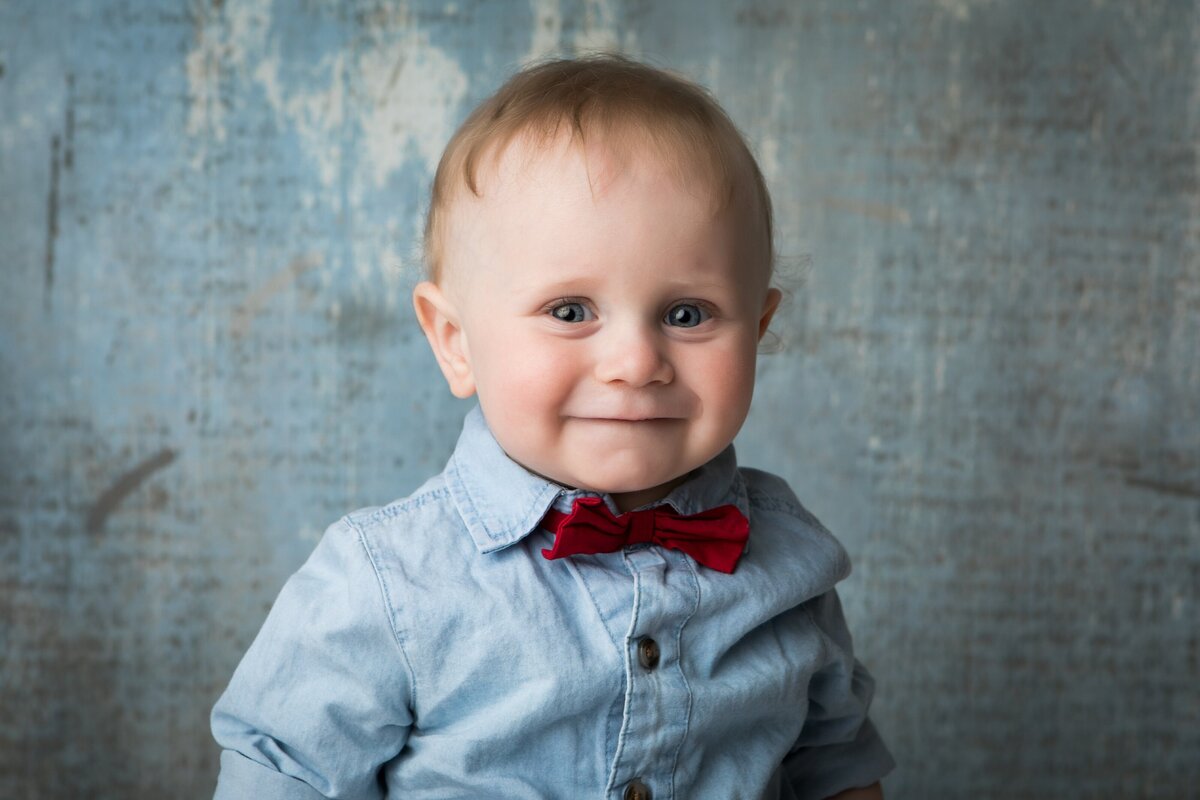 Toddler in bow tie smiling at camera