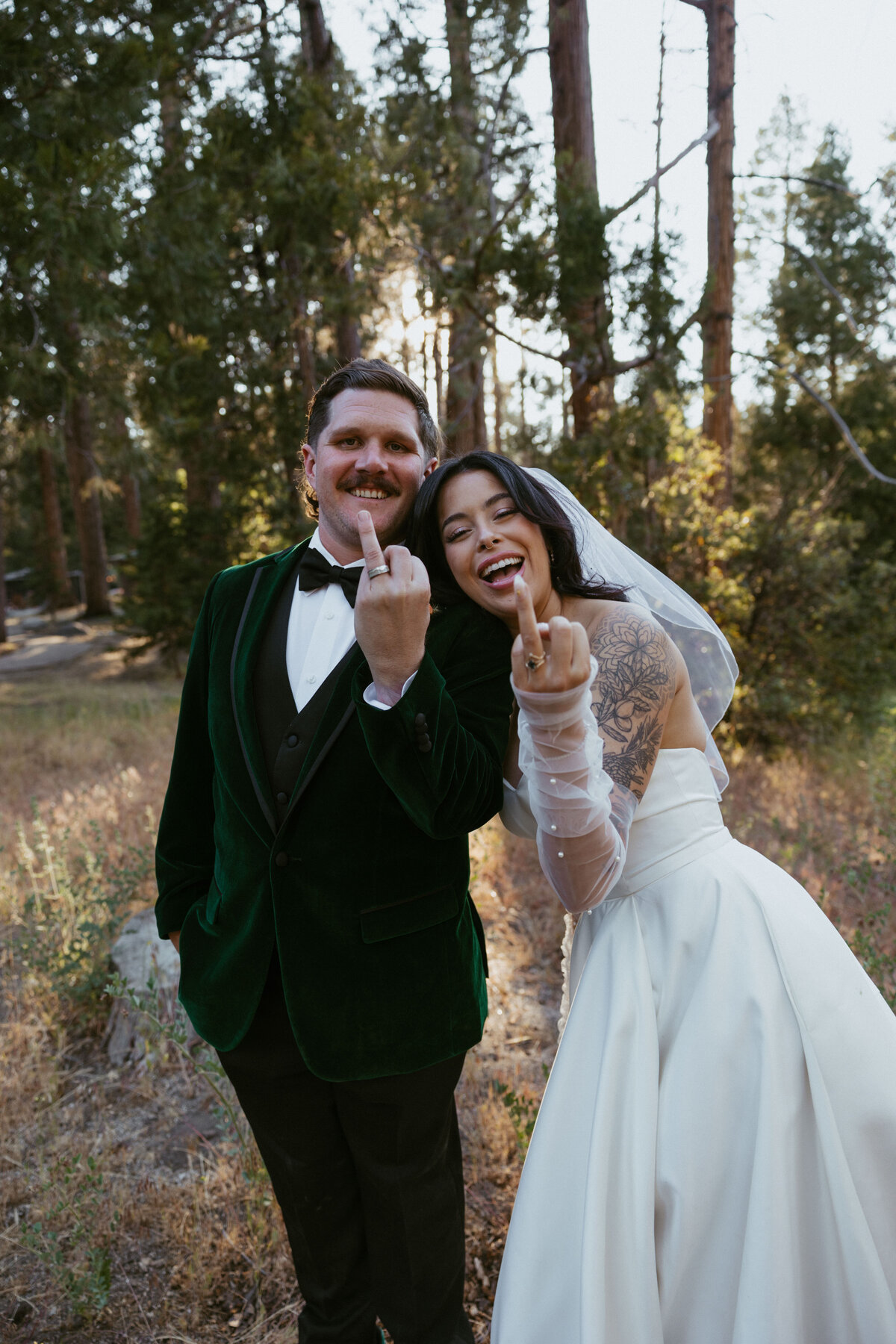 bride and groom smiling at camera showing off rings