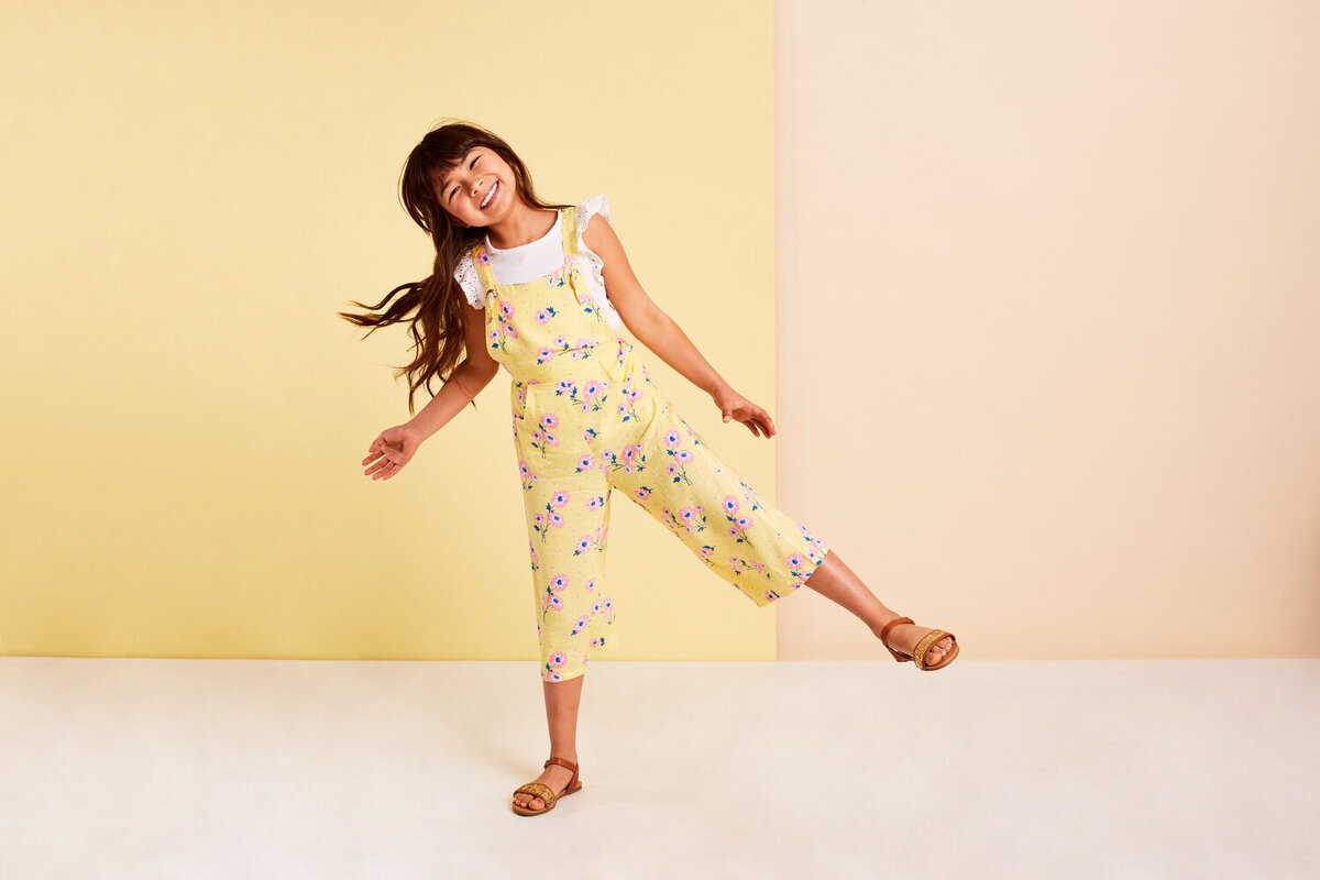 Greer Rivera Photography Kids Editorial Photoshoots Marin CA Girl standing on one foot in yellow overalls