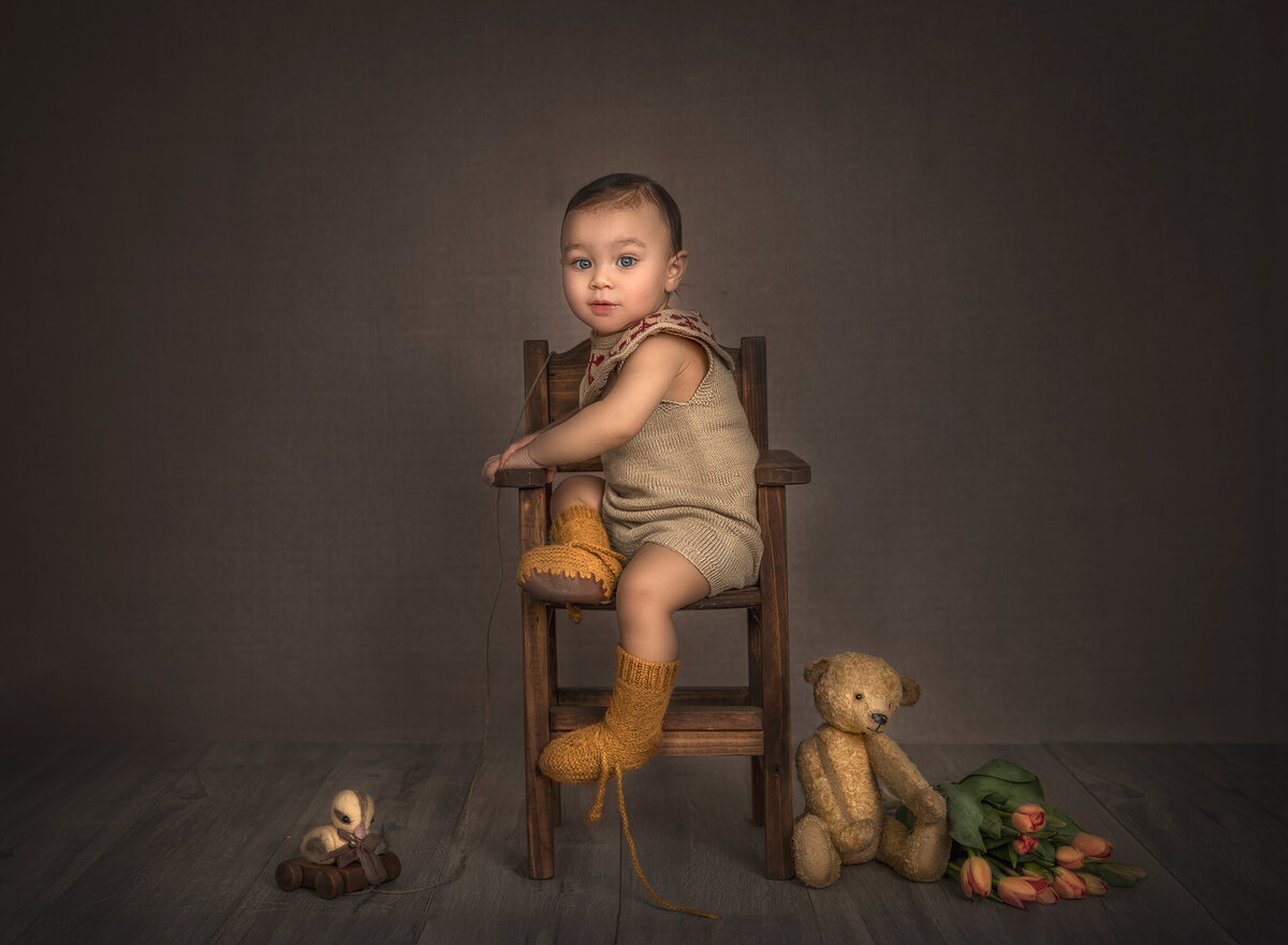 One-year-old baby sitting in a chair against a simple, timeless backdrop – Ottawa milestone photography