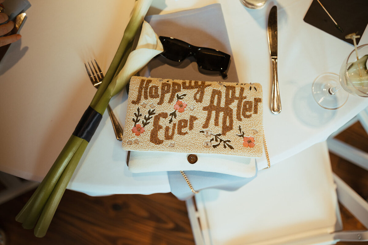 A small purse with the words "Happily Ever After" on it 