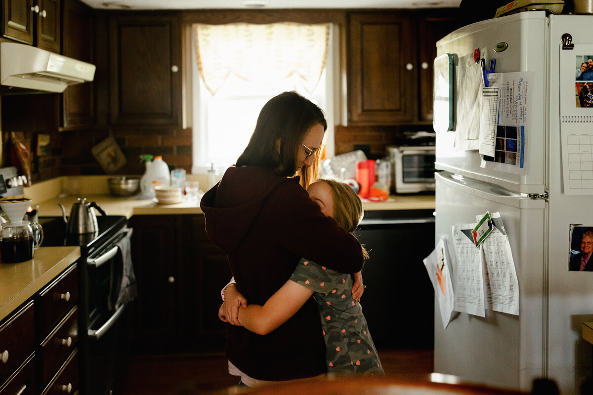 mom-hugging-daughter-kitchen