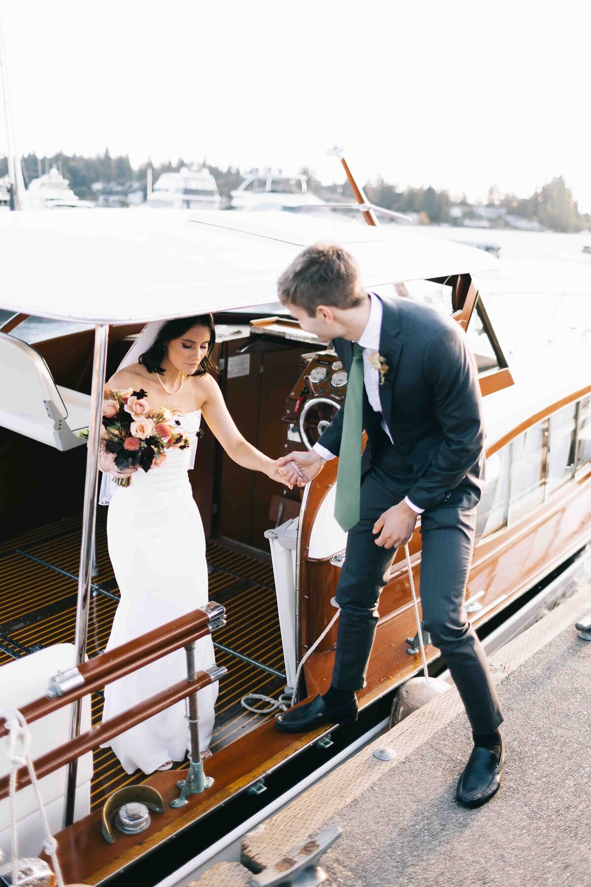 Bride and groom taking a boat ride on Lake Washington at Woodmark Hotel