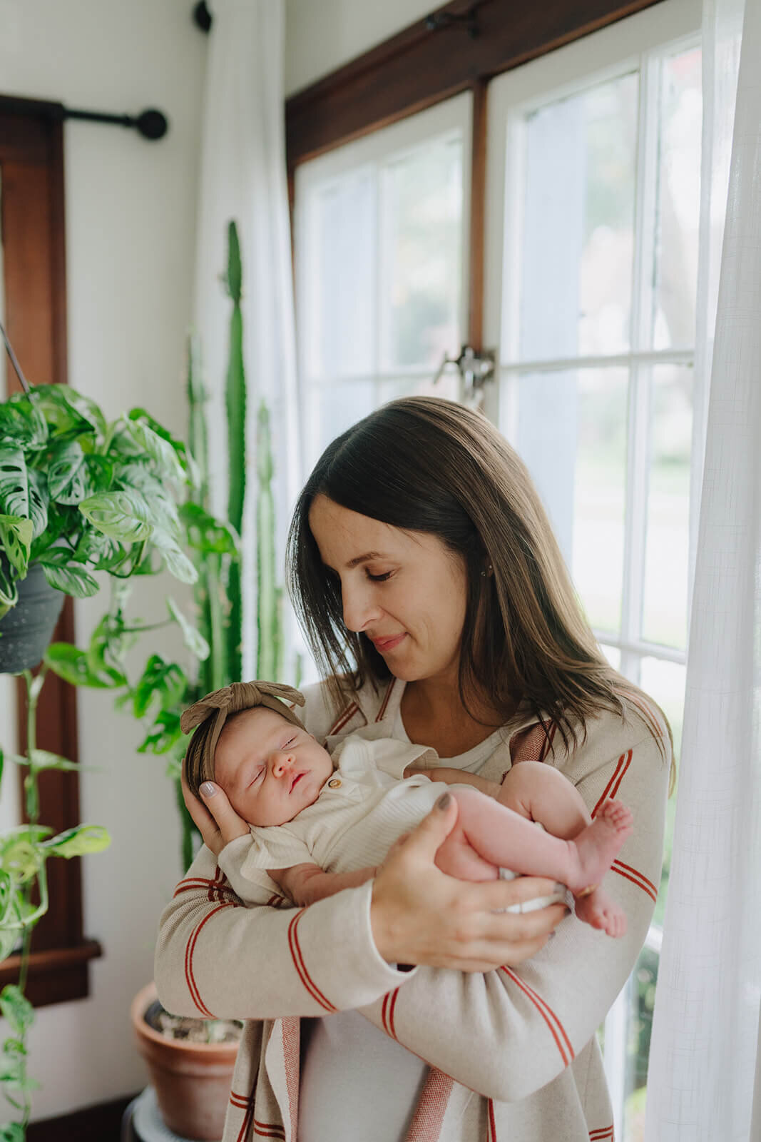 Woman holding baby at newborn photoshoot at Finger Lakes, NY