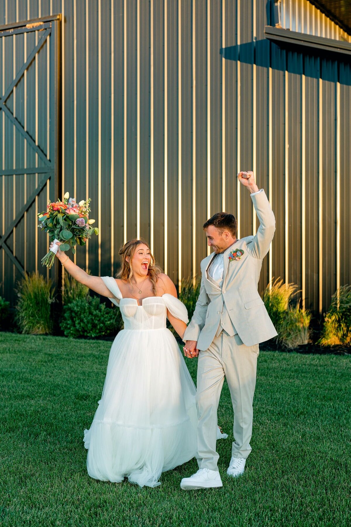 Bride_Groom_Holding_Hands_Celebrating