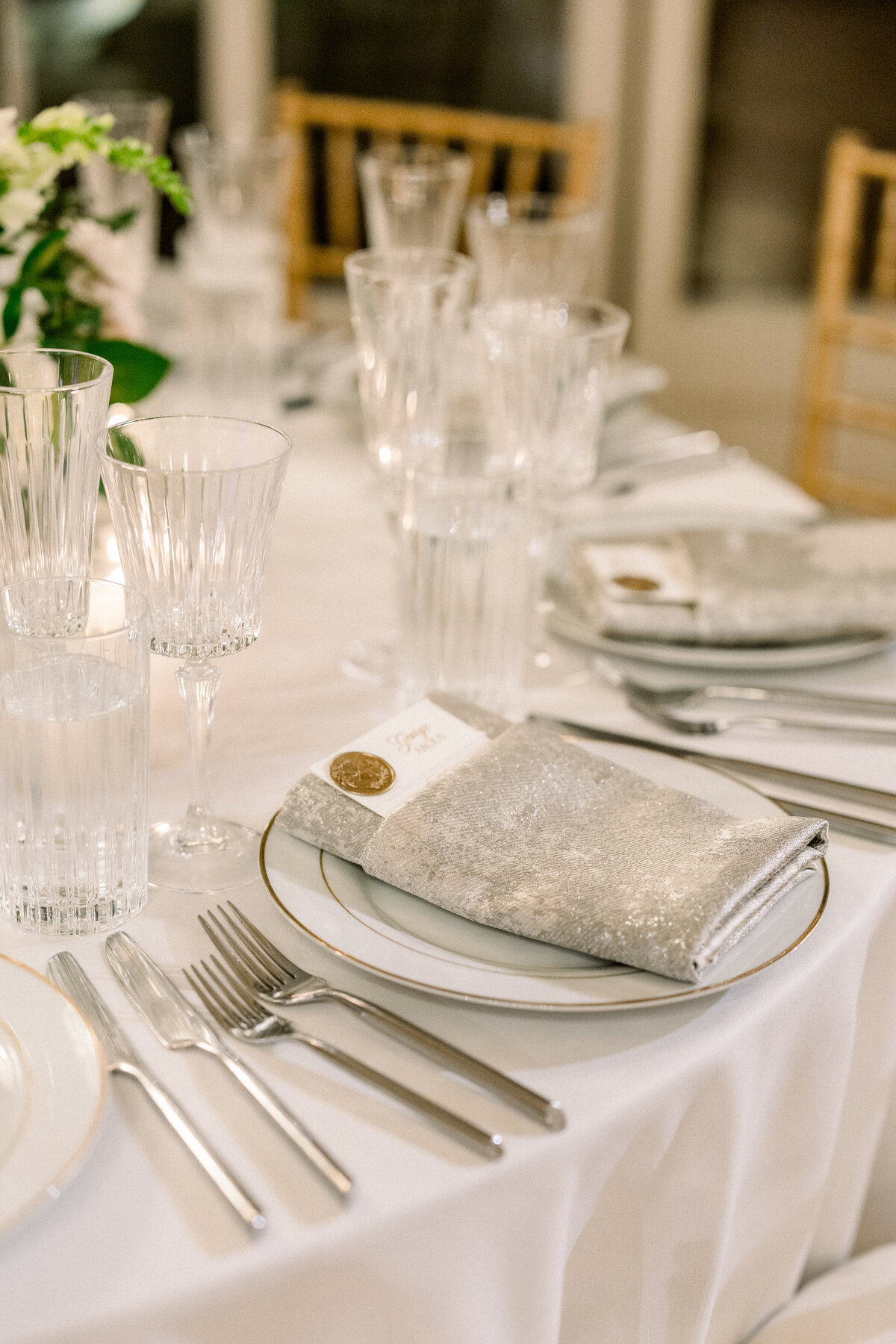 silver napkin and glamarous place setting on tablescape at rosecliff mansion