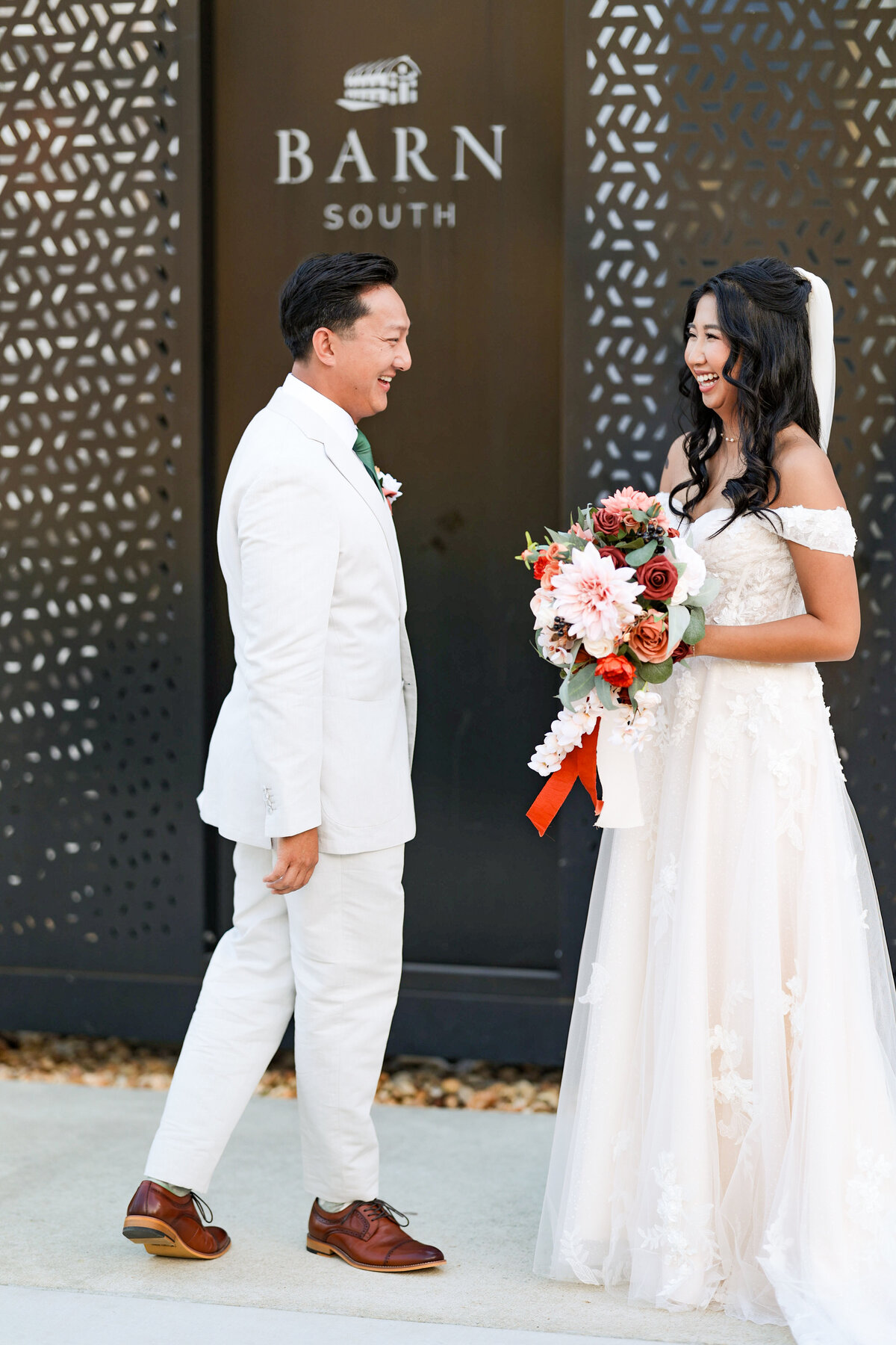 Couple sharing a fun laugh before ceremony at Barn South in Pendergrass, GA. 