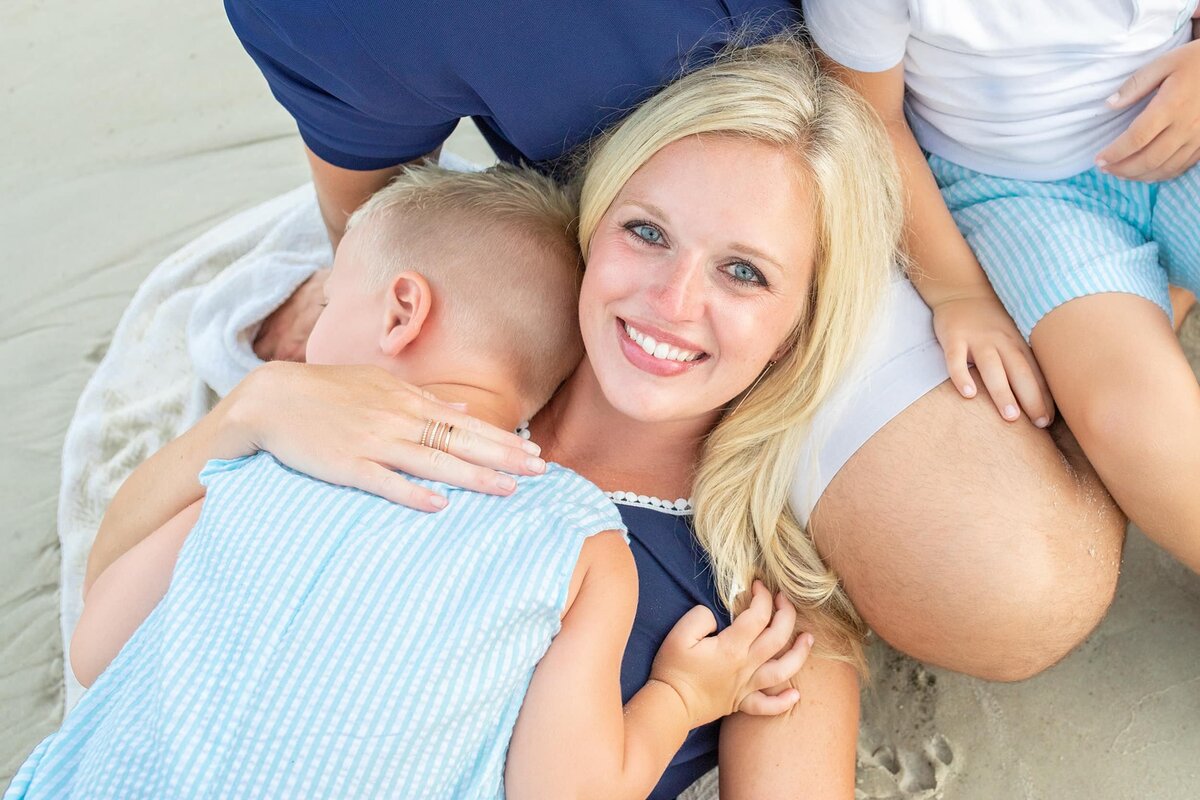 Mom holds little boy tight at the beach