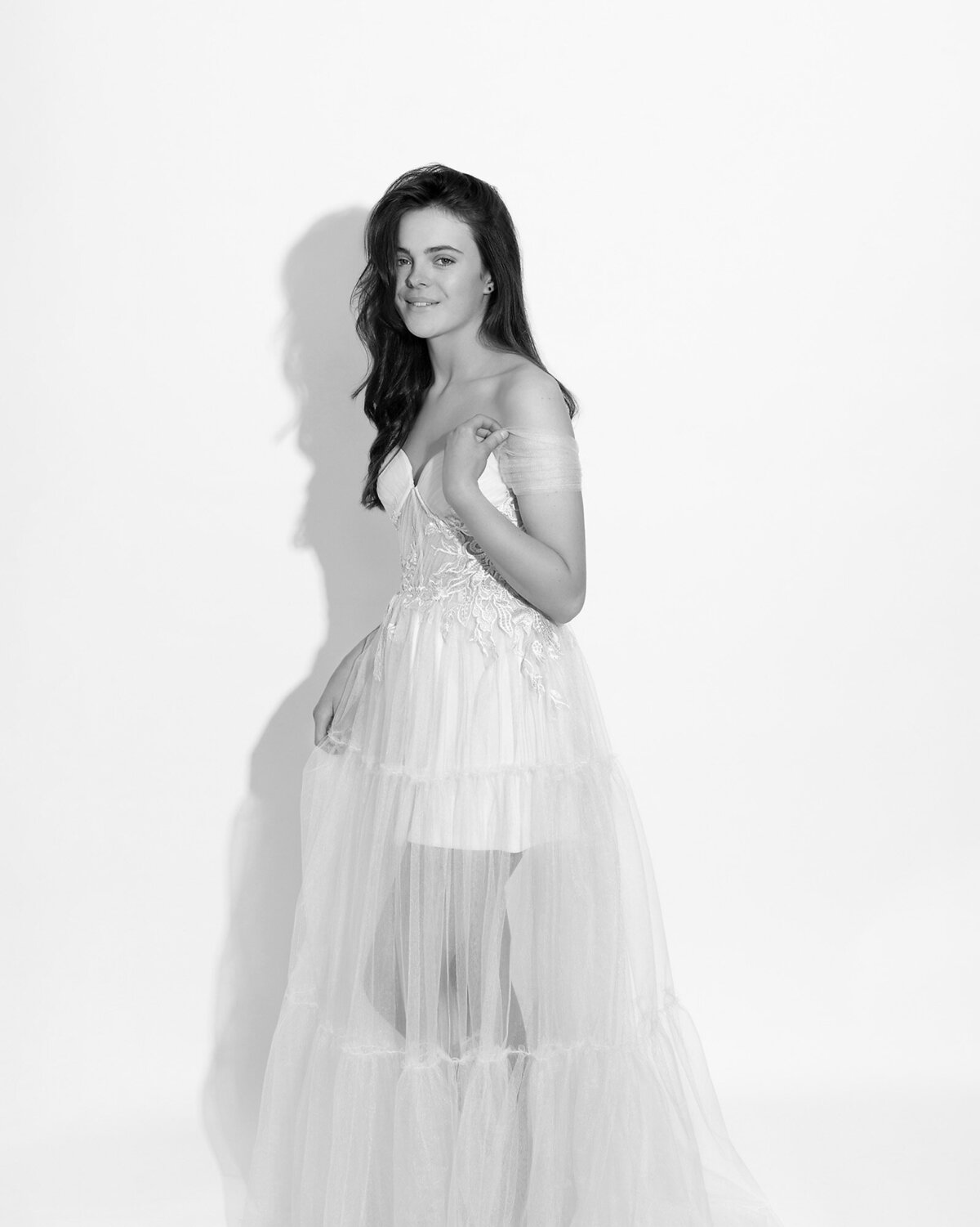 Black and white teen girls portrait wearing gorgeous tulle dress on a simple white background