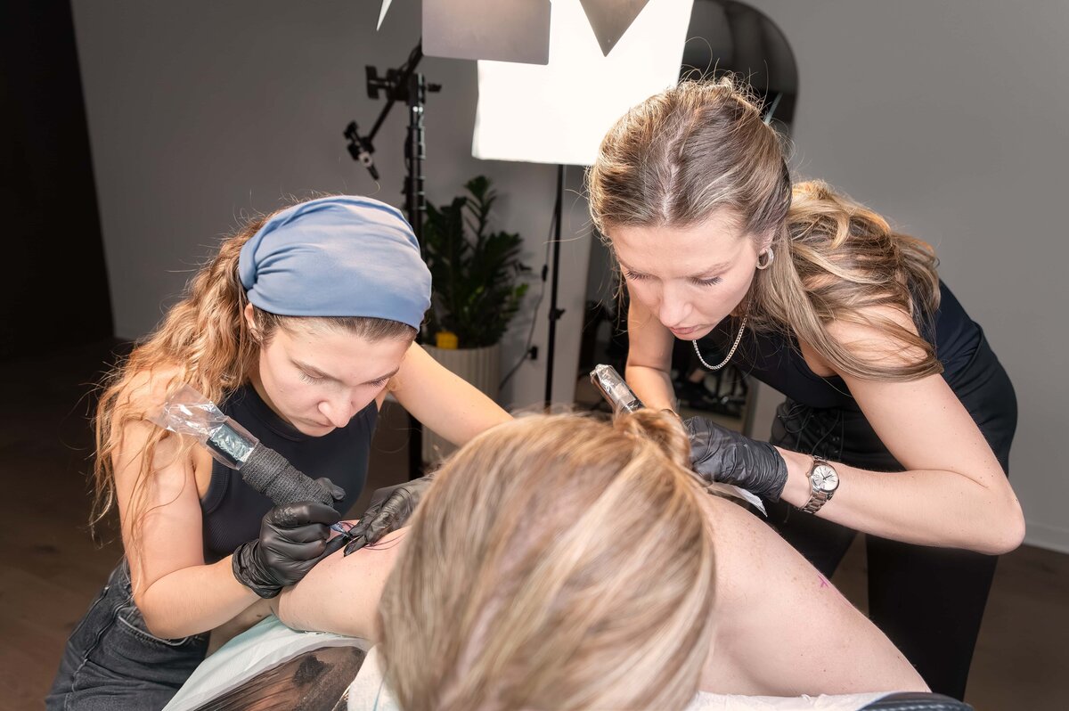 Alicia LaPierre Photography image of two sisters tattooing a client