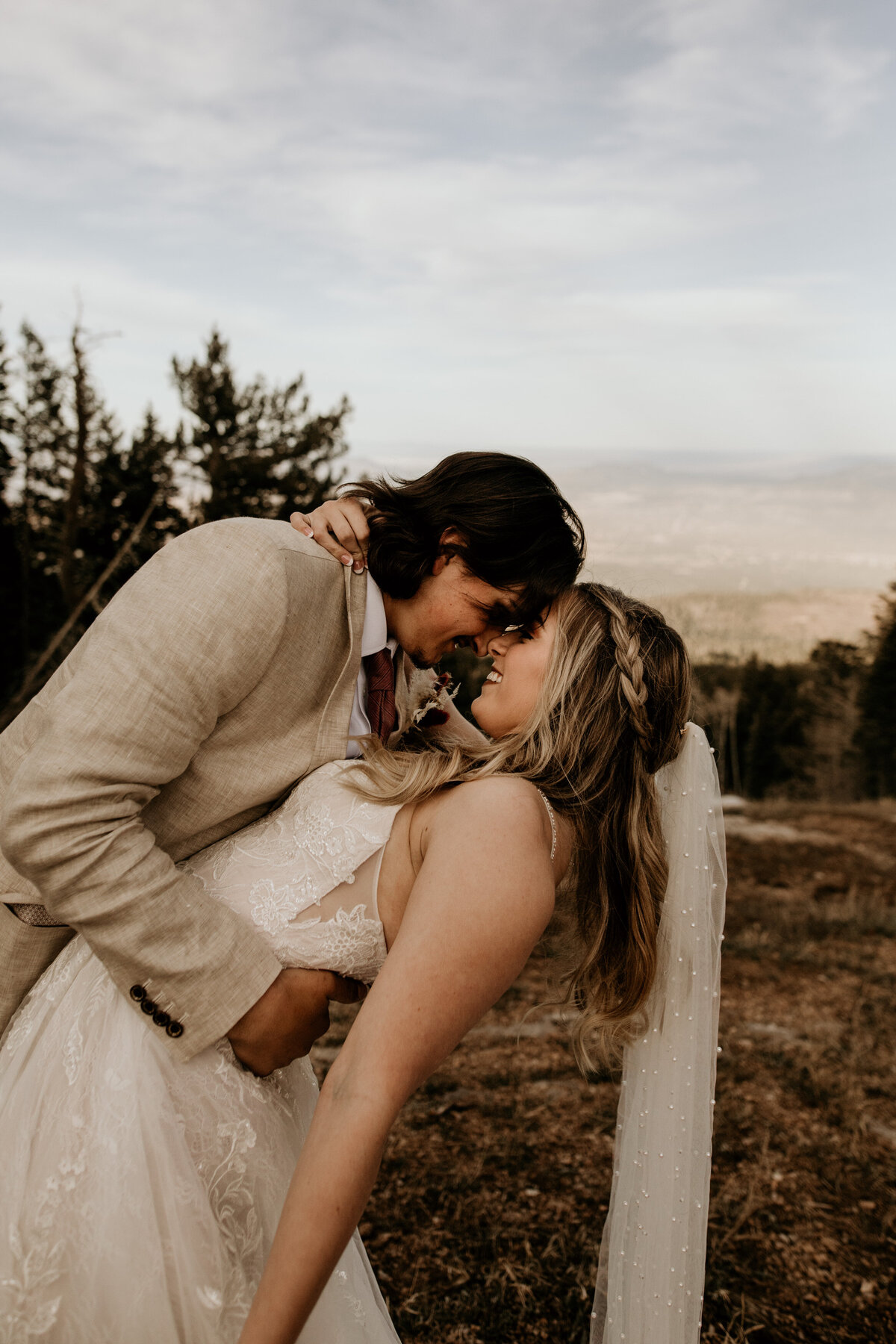 bride and groom kissing on top of the Sandia Mountains