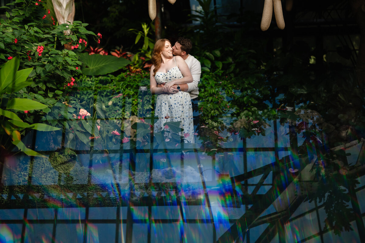 A couple embrace inside Lincoln Park Conservatory 