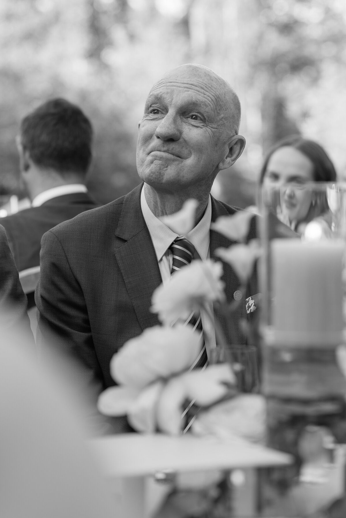 An emotional image of a father of the groom listening to speeches at a wedding