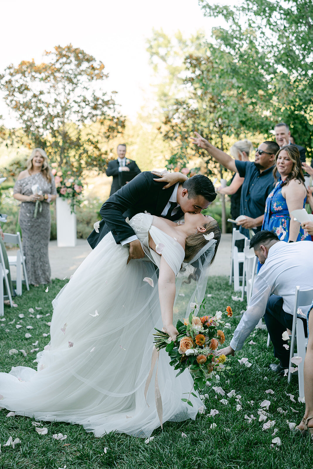 bride and groom at park winters wedding peach pastel flowers