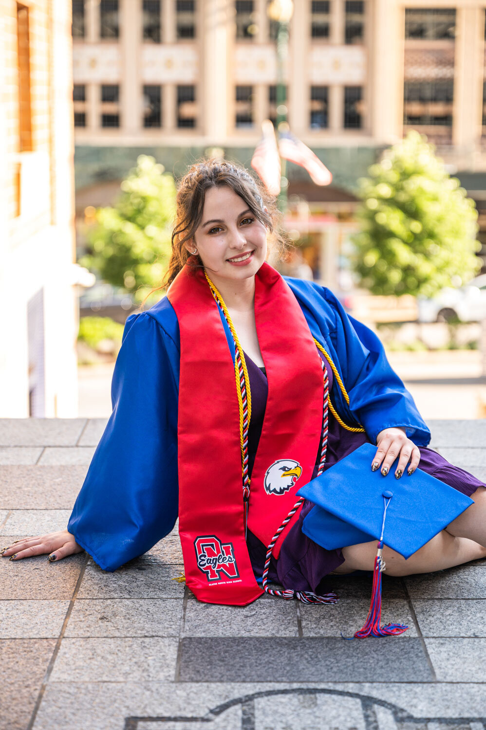 GIRL SITTING IN GRADUATION UNIFORM