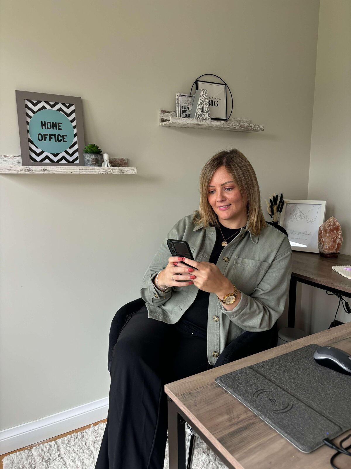 Amy, founder of Remote Results and social media manager for coaches, creatives, and wellness pros, optimizing social media content on her phone.