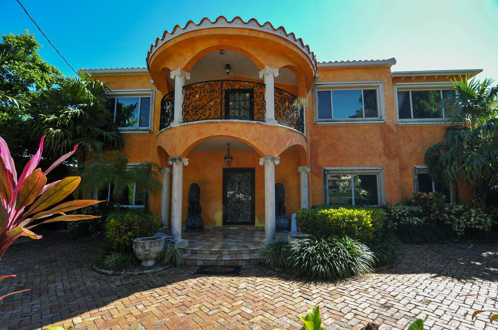 front of a two floor house with columns