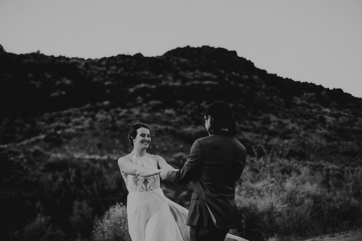 bride and groom holding hands and spinning