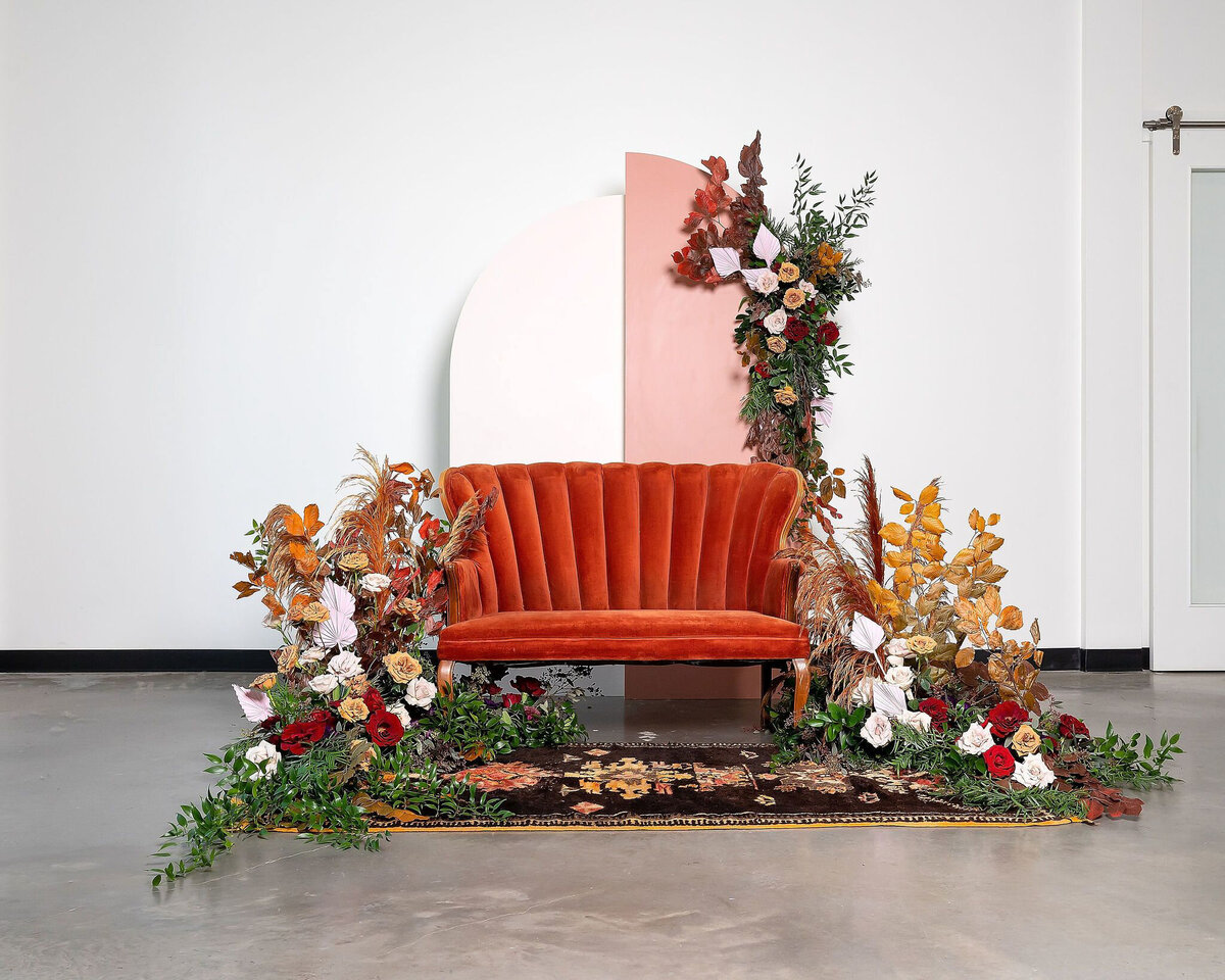 Arched wedding backdrop, red and rust coloured florals including rentals from Stef Forward Events, trendy and modern decor rentals based in Calgary, AB. Featured on the Brontë Bride Vendor Guide.