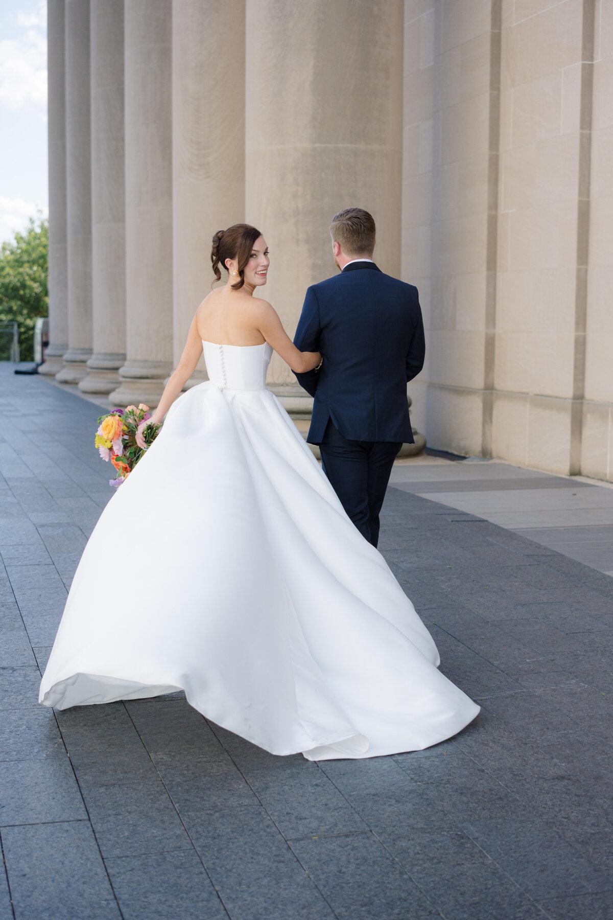 bride and groom walking at the Nelson-Atkins Museum