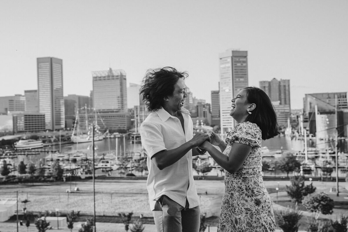 A couple holding hands and laughing together 