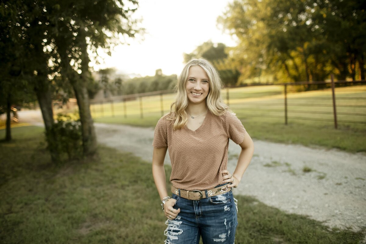 A high school senior strikes a playful pose, letting their personality shine through