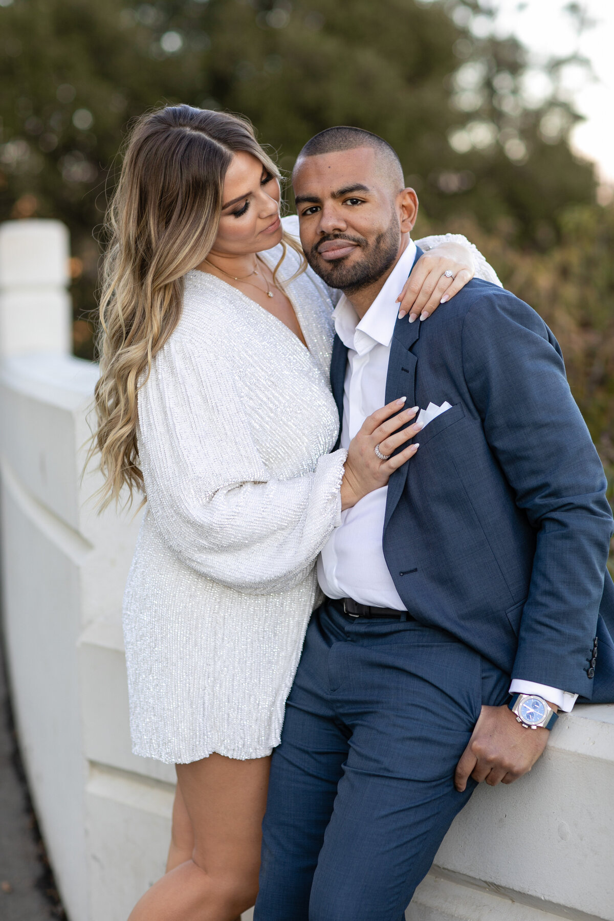 Groom wearing blue jacket and  female wearing a short white dress