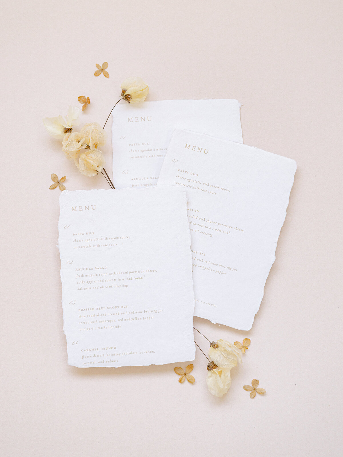 Elegant wedding menu with calligraphy and deckled edges