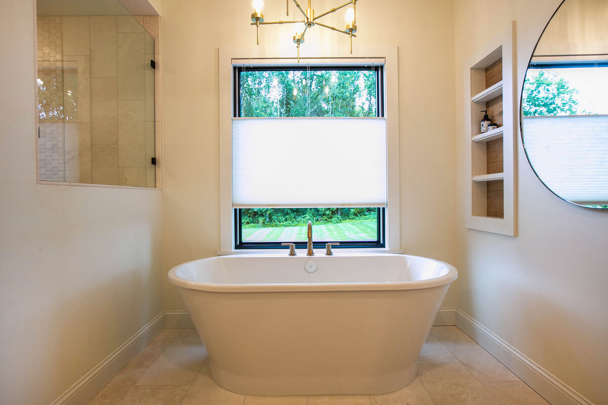Custom bathroom with soaking tub, double vanity, and walk-in shower in Otsego custom home