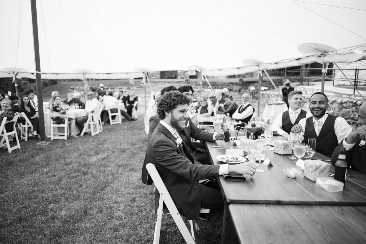 guests sitting at dinner under tent at connors center wedding